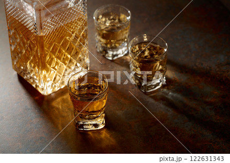 Decanter and small glasses of whiskey. Decanter and small glasses of whiskey. 122631343