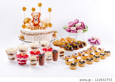Celebration dessert table featuring a teddy bear cake and assorted sweet treats for a special occasion Celebration dessert table featuring a teddy bear cake and assorted sweet treats for a special occasion 122632753