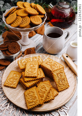 Enjoying an afternoon tea with assorted cookies and herbal tea in a cozy setting 122632961