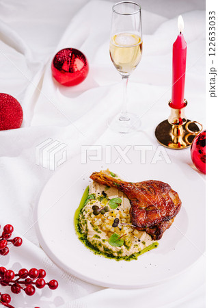 Delicious duck leg served with creamy mashed potatoes and festive decorations for a special occasion 122633033