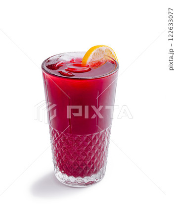 Refreshing red beverage with lemon slice served in crystal glass with ice 122633077
