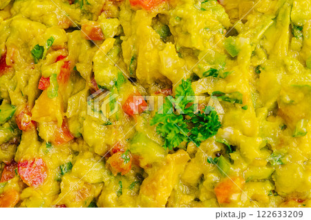 Guacamole prepared with fresh ingredients at a vibrant outdoor gathering in sunny weather 122633209