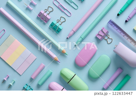 Stationery background with pastel-colored stationery neatly arranged on a light blue background. Back to school concept. Stationery background with pastel-colored stationery neatly arranged on a light blue background. Back to school concept. 122633447