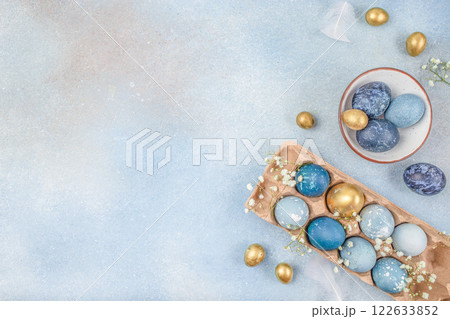 blue and golden eggs on a blue background. Easter card. top view. copy space blue and golden eggs on a blue background. Easter card. top view. copy space 122633852