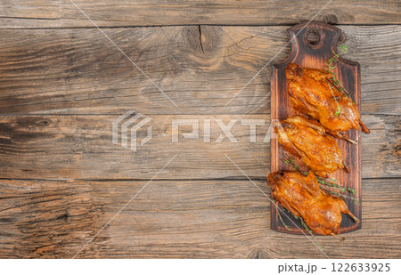 Baked quail with herbs. Flat lay. Top view. Free copy space Baked quail with herbs. Flat lay. Top view. Free copy space 122633925