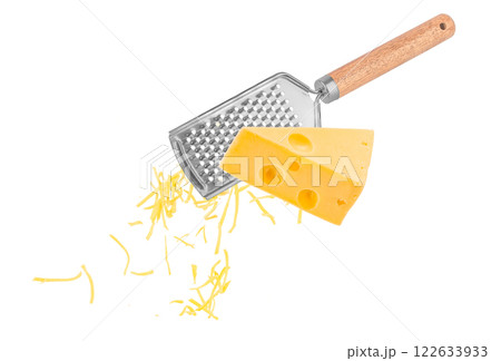 Piece of cheese is rubbed on a hand grater isolated on white Piece of cheese is rubbed on a hand grater isolated on white 122633933