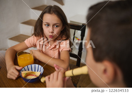 Young girl and boy interacting during leisurely activity at home 122634533