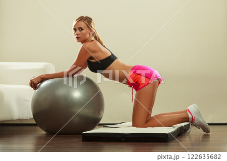 woman doing fitness exercises with fit ball woman doing fitness exercises with fit ball 122635682