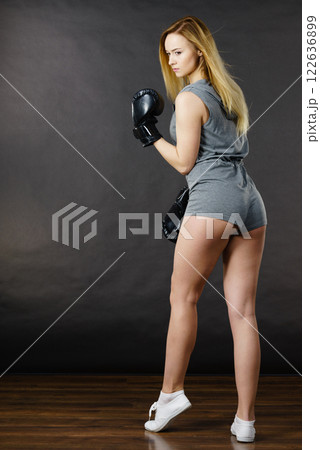 Boxer girl exercise with boxing gloves. 122636899