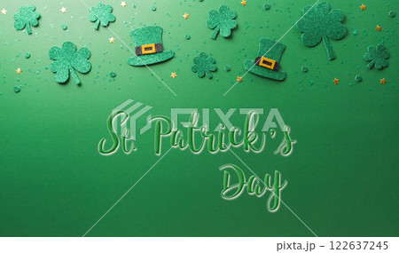 Happy St Patrick's Day decoration concept made from shamrocks ( clover leaf) and leprechaun hat on green background. 122637245