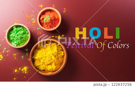 Happy Holi decoration, the indian festival.Top view of colorful holi powder on dark background. Happy Holi decoration, the indian festival.Top view of colorful holi powder on dark background. 122637256