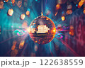 A disco ball is suspended from the ceiling at party, reflecting the lights 122638559
