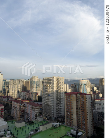 View of old district of Batumi in Georgia from window. High view of residential area of Batumi with old houses and mountains in background. Vertical photograph of the cityscape View of old district of Batumi in Georgia from window. High view of residential area of Batumi with old houses and mountains in background. Vertical photograph of the cityscape 122639479