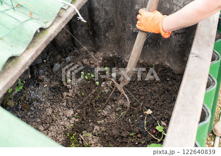 Man Working in Organic Garden Composting Pit Man Working in Organic Garden Composting Pit 122640839