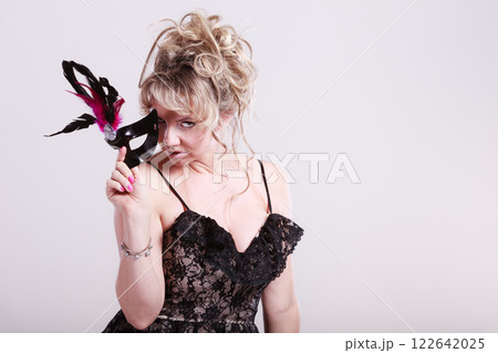 Woman middle aged holds carnival mask. Woman middle aged holds carnival mask. 122642025