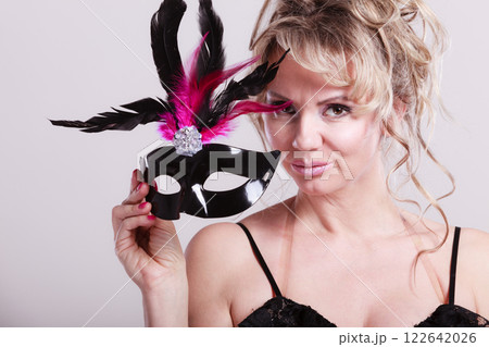 Woman middle aged holds carnival mask. Woman middle aged holds carnival mask. 122642026