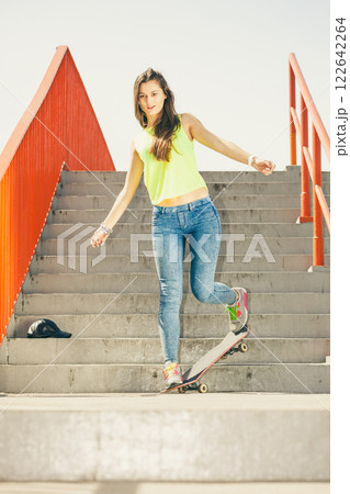 Girl on stairs with skateboard. Girl on stairs with skateboard. 122642264