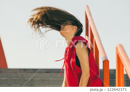 Girl on stairs in city. 122642371