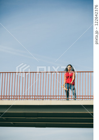 Urban skate girl with skateboard. 122642376