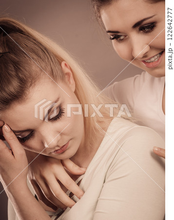Woman hugging her sad female friend 122642777