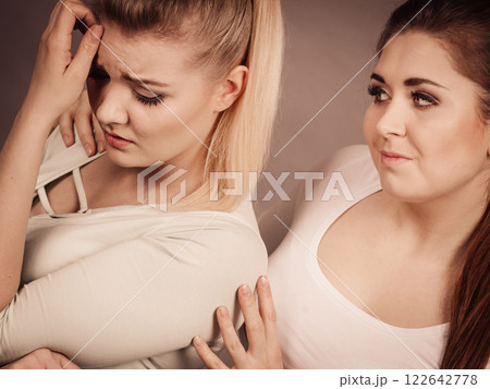 Woman hugging her sad female friend 122642778