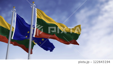 Flags of Lithuania and the European Union waving together on a clear day Flags of Lithuania and the European Union waving together on a clear day 122643194