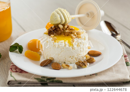 Healthy cottage cheese dessert with nuts and dried fruits Healthy cottage cheese dessert with nuts and dried fruits 122644678