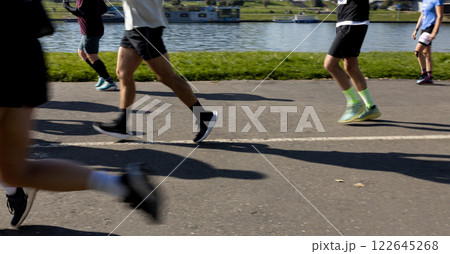 Motion blurred marathon runners in a city. Group of marathon runners compete in the race outdoors 122645268