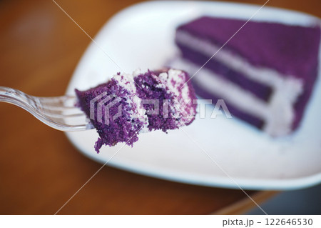 A Delicious Slice of Ube Cake Placed on a Plate with a Fork A Delicious Slice of Ube Cake Placed on a Plate with a Fork 122646530