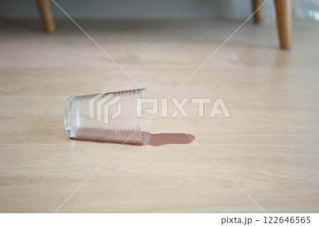 Accident Prone A Glass Has Been Spilled on the Wooden Floor Accident Prone A Glass Has Been Spilled on the Wooden Floor 122646565
