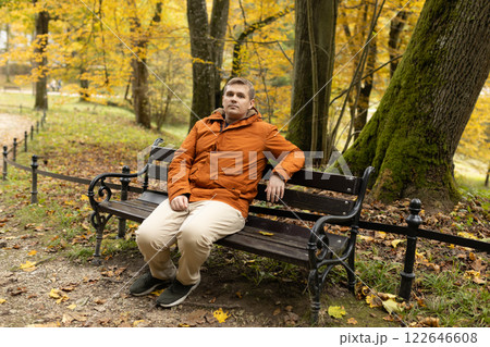 Young sad 30s man sitting alone on bench in autumn park. Thinking about life. Spending time alone in nature. Tired lost human guy wait, worship God Young sad 30s man sitting alone on bench in autumn park. Thinking about life. Spending time alone in nature. Tired lost human guy wait, worship God 122646608