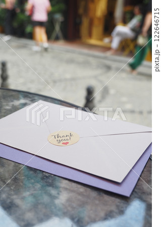 Vertical Shot of A Thank You Note featuring a charming Heart Sticker placed thoughtfully on a Table Vertical Shot of A Thank You Note featuring a charming Heart Sticker placed thoughtfully on a Table 122646715