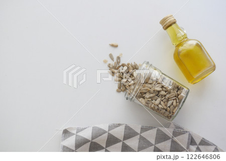 Top View of Sunflower Seeds in Jar and Bottle of Vegetable Oil 122646806