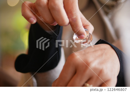 woman rubbing ice cube on her hand. woman rubbing ice cube on her hand. 122646807