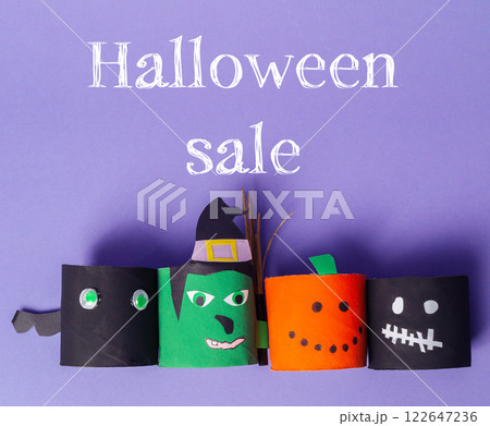 Halloween sale with four paper cutouts of Halloween characters 122647236