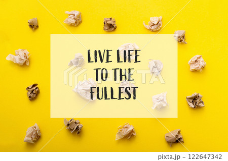 Yellow background with a bunch of crumpled paper on it Yellow background with a bunch of crumpled paper on it 122647342