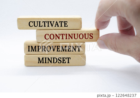 Cultivate continuous improvement mindset text on wooden blocks. Continuous Improvement concept 122648237