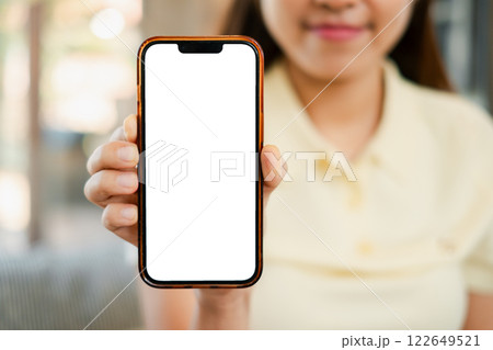 Close-up of a woman showing a smartphone with a blank screen, perfect for app or website mockups. Close-up of a woman showing a smartphone with a blank screen, perfect for app or website mockups. 122649521