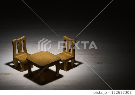 スポットライトに照らされたミニチュアのテーブルとイス 122652308