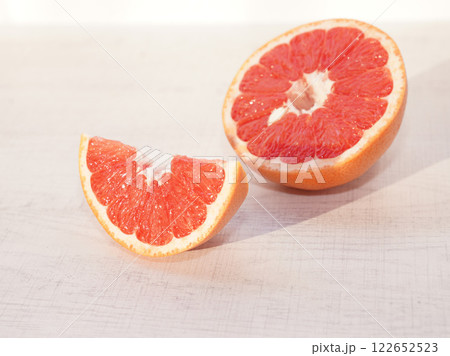 Sliced grapefruit on table with sunshine. 122652523