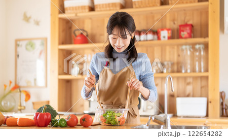キッチンで料理をする女性（サラダを作る） 122654282