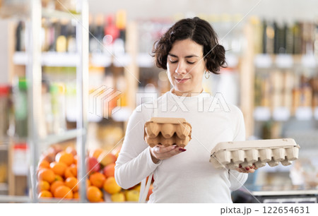 In store, woman near counter are looking at varieties of eggs 122654631