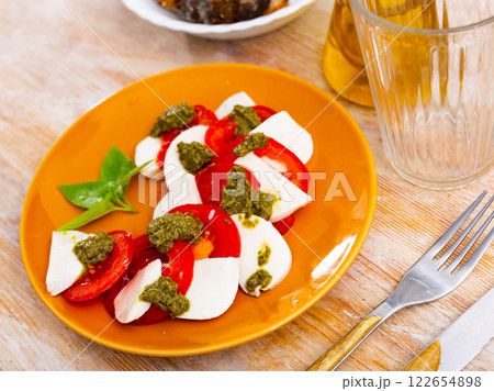 Caprese salad with tomatoes, mozzarella, basil, pesto Caprese salad with tomatoes, mozzarella, basil, pesto 122654898