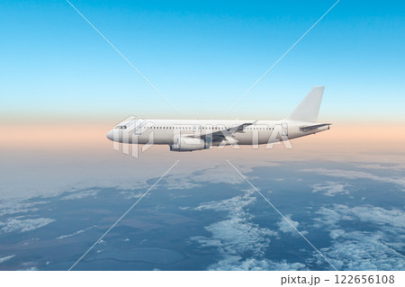 White passenger airliner fly in the air above the clouds 122656108