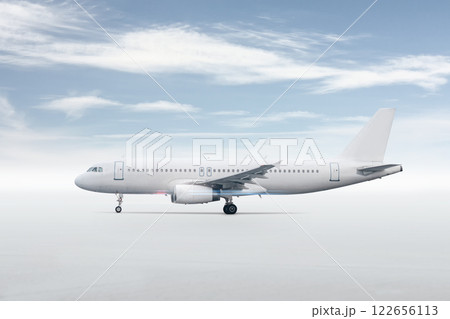 White passenger airliner isolated on bright background with sky 122656113