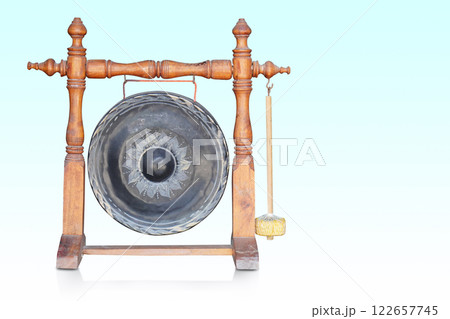 front view Antique Burmese Bronze Temple Gong with Mallet Mounted on Turned Wooden Stand on gradient blue and white background, object, buddha, thai, object, copy space 122657745