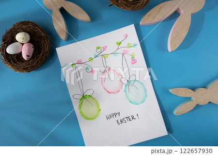 Handmade greeting card with EASTER eggs HAPPY EASTER written in beautiful handwriting. Gesture shows excitement and joy for the upcoming event. Springtime holiday gift present zero cost ideas Handmade greeting card with EASTER eggs HAPPY EASTER written in beautiful handwriting. Gesture shows excitement and joy for the upcoming event. Springtime holiday gift present zero cost ideas 122657930