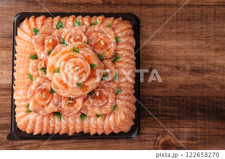 Salmon Sashimi Arranged as Flowers on a Black Tray Salmon Sashimi Arranged as Flowers on a Black Tray 122658270
