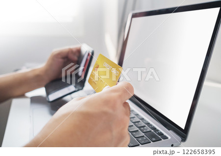 Close-up of hand holding credit card from wallet to online shopping. Cashless technology and credit card payment concept. 122658395