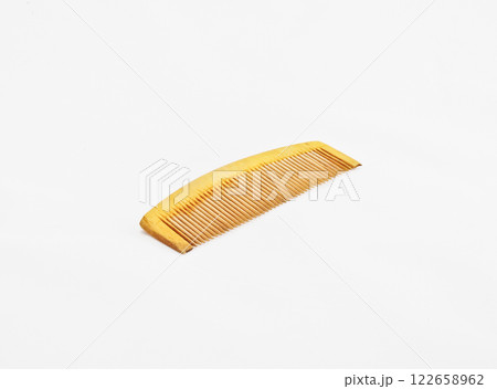 A wooden comb on a white background with copy space A wooden comb on a white background with copy space 122658962
